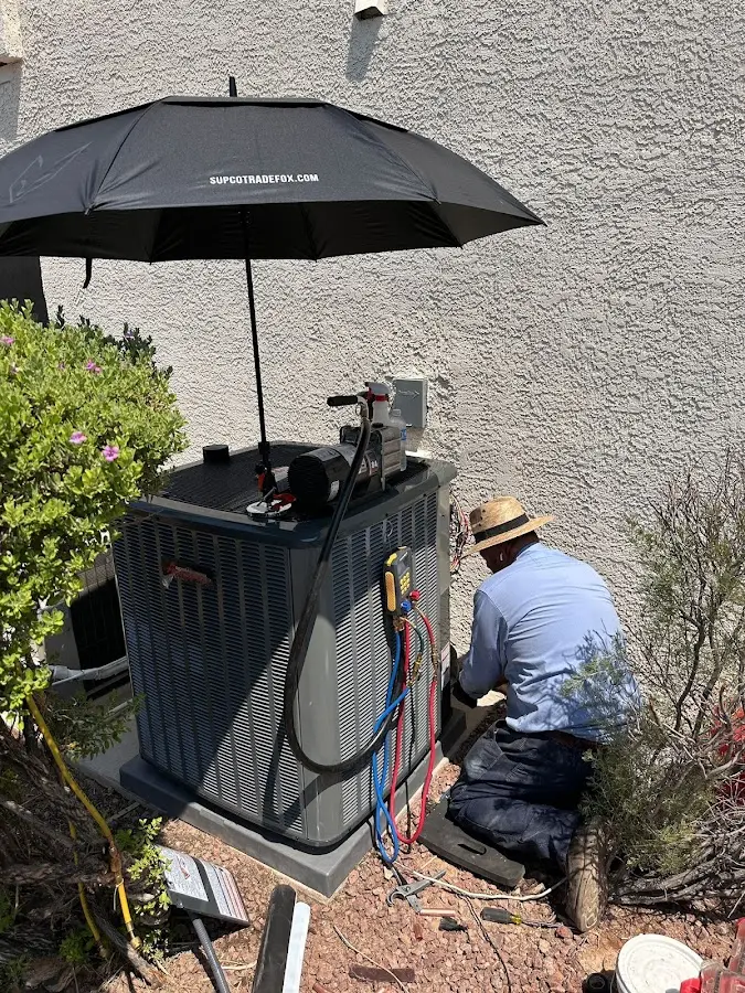 HVAC technician performing outdoor AC maintenance in Jennings Lodge